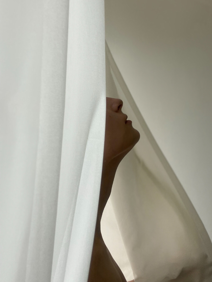 woman profile behind curtain